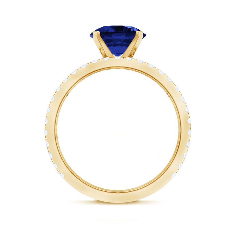 Round lab-grown blue sapphire solitaire ring set with diamond accents from Rosec Jewels, featuring a sleek and elegant design.