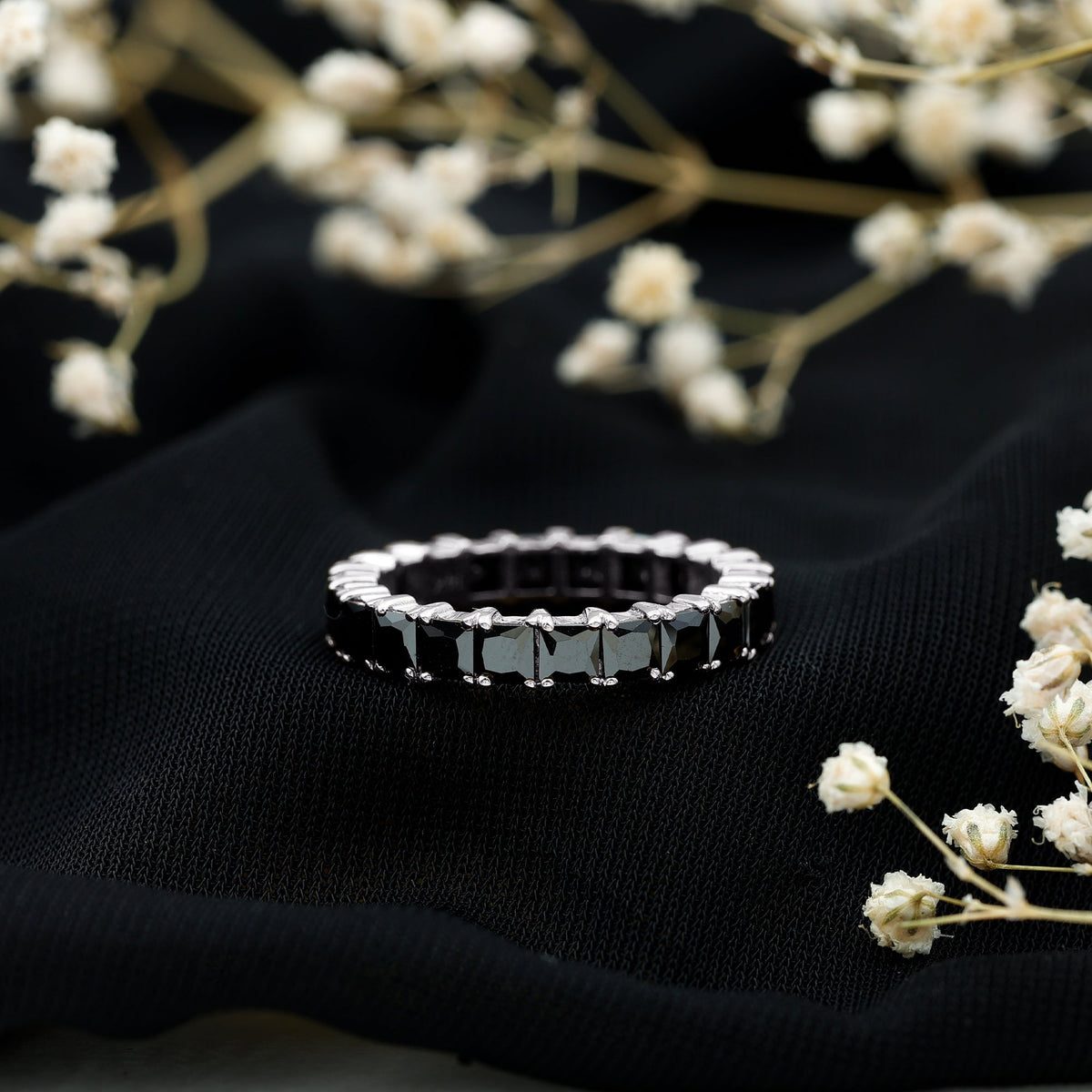 Black spinel eternity band ring with princess cut stones by Rosec Jewels, showcasing a continuous row of sparkling black gemstones.