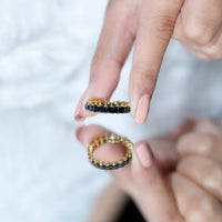 Rosec Jewels black spinel eternity band ring with princess cut stones, showcasing a sleek and elegant design.