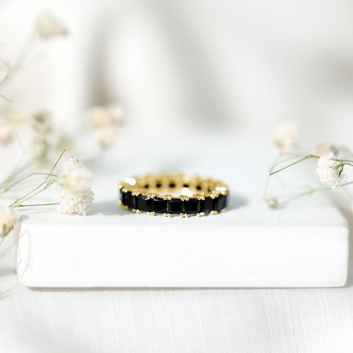 Certified black spinel princess cut eternity band ring by Rosec Jewels, showcasing a continuous row of sparkling black spinel gemstones.