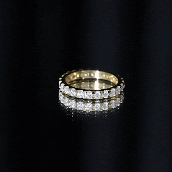 Yellow gold eternity ring with brilliant cut round moissanite stones, featuring a continuous gemstone band by Rosec Jewels.