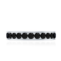 Black spinel eternity ring by Rosec Jewels featuring a channel set design with sparkling black gemstones around the band.