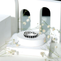 Black spinel eternity band ring with 2.25 carats of round stones, crafted by Rosec Jewels, showcasing a continuous circle of sparkle.