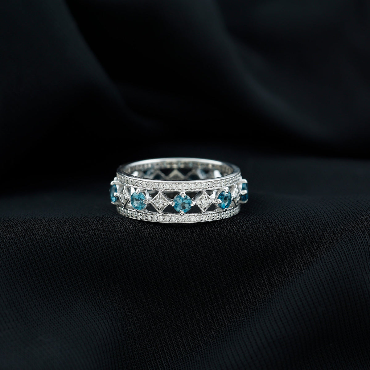 Vintage-inspired London Blue Topaz eternity ring with diamonds by Rosec Jewels, featuring a band of vibrant blue gemstones and sparkling diamonds.