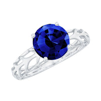 Lab-created blue sapphire solitaire ring with filigree shank by Rosec Jewels, showcasing a vibrant blue sapphire gemstone and intricate metalwork.
