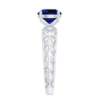 Lab-created blue sapphire solitaire ring with intricate filigree shank by Rosec Jewels, showcasing a vibrant blue gemstone.