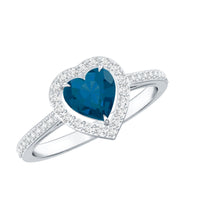 Heart-shaped London Blue Topaz engagement ring with diamond halo, featuring intricate detailing from Rosec Jewels.