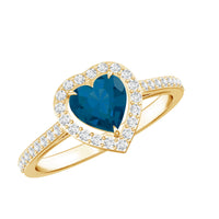 Heart-shaped London Blue Topaz engagement ring with diamond halo from Rosec Jewels, showcasing a sparkling blue gemstone and elegant design.