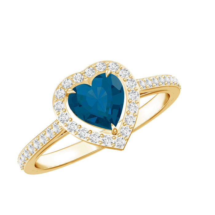 Heart-shaped London Blue Topaz engagement ring with diamond halo from Rosec Jewels, showcasing a sparkling blue gemstone and elegant design.