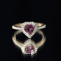 Heart-shaped pink tourmaline engagement ring with diamond halo from Rosec Jewels, showcasing a stunning pink gemstone and sparkling diamonds.
