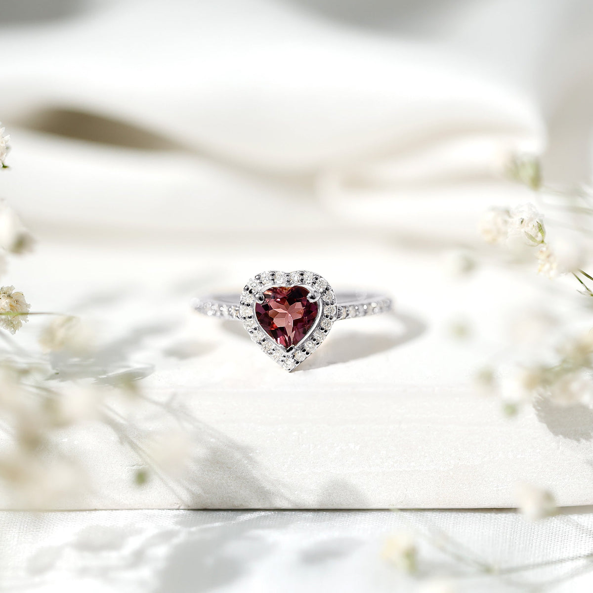 Heart-shaped pink tourmaline engagement ring with diamond halo, crafted by Rosec Jewels, featuring a stunning and romantic design.