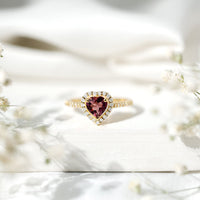 Pink heart-shaped tourmaline engagement ring with diamond halo from Rosec Jewels, showcasing the detailed gemstone and elegant design.