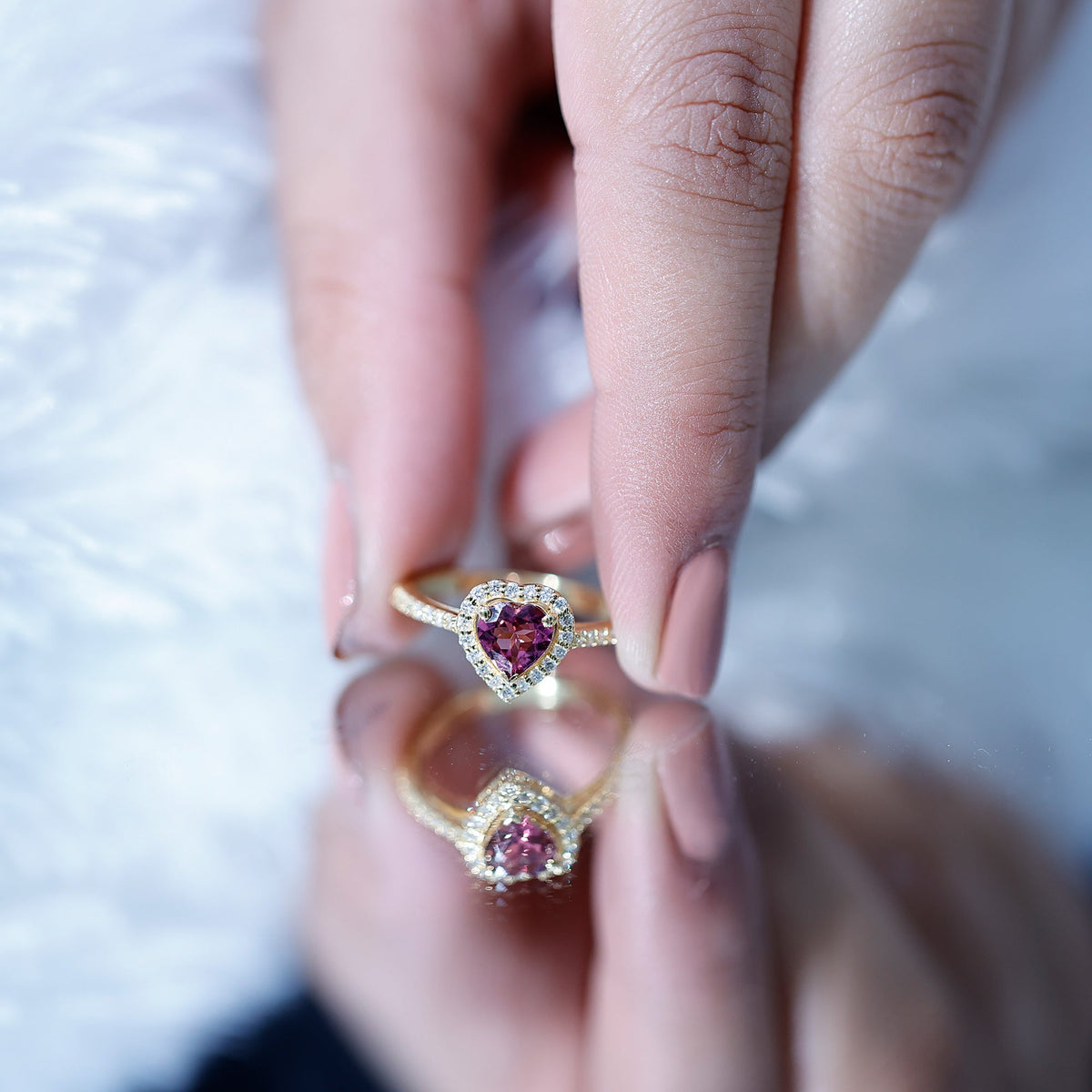 Pink heart-shaped tourmaline engagement ring with diamond halo from Rosec Jewels, showcasing a sparkling gemstone and elegant design.