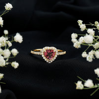 Pink heart-shaped tourmaline engagement ring with diamond halo by Rosec Jewels, showcasing a romantic design and sparkling accents.