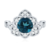 Rosec Jewels London Blue Topaz and Diamond cocktail flower engagement ring with intricate design and sparkling gemstones.