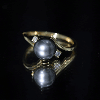 Vintage engagement ring featuring a natural Tahitian black pearl and diamonds by Rosec Jewels, showcasing intricate design and craftsmanship.