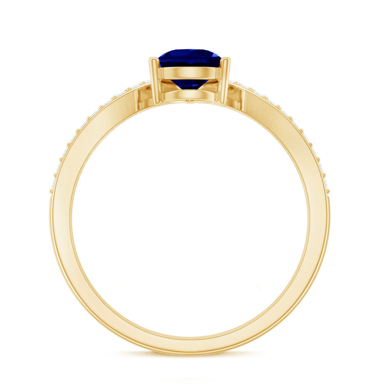 Pear shape lab-grown blue sapphire engagement ring with diamond accents, crafted by Rosec Jewels.