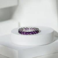 Rosec Jewels princess cut amethyst full eternity band ring showcasing alternating purple gemstones and sleek silver band.