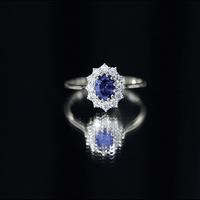 Oval lab-grown blue sapphire engagement ring with diamonds, 1.5 carats, by Rosec Jewels, featuring a yellow gold band and elegant design.