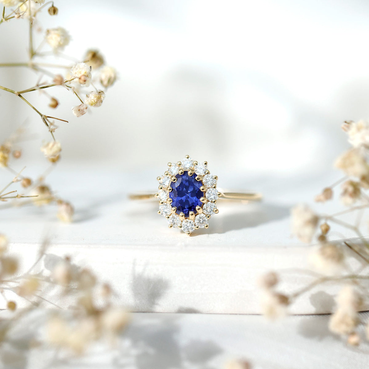 Rosec Jewels 1.5 carat oval lab-grown blue sapphire engagement ring with diamond accents, featuring a classic princess Diana style design.