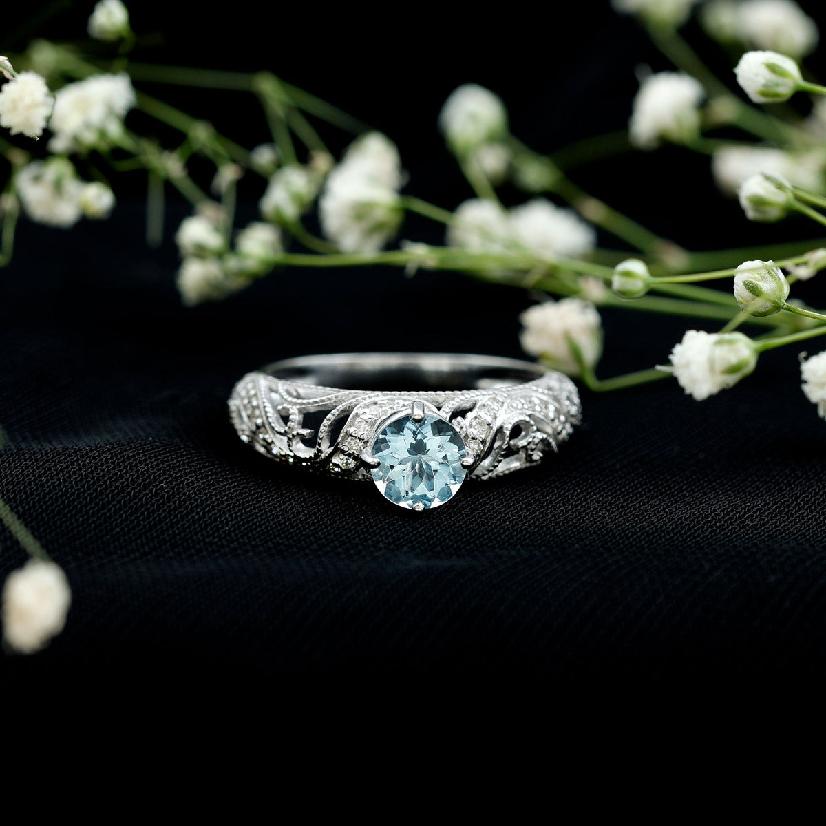 Vintage style aquamarine and diamond engagement ring by Rosec Jewels featuring a 0.8 carat central gemstone and intricate design.