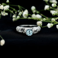 Vintage style aquamarine and diamond engagement ring by Rosec Jewels featuring a 0.8 carat central gemstone and intricate design.