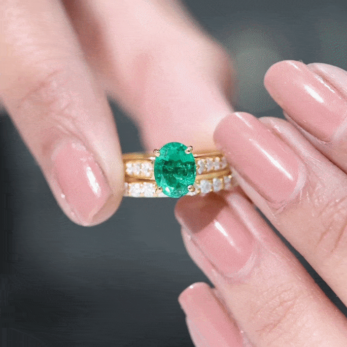 Pair of rose gold wedding rings with oval lab-grown emeralds, featuring one set from Rosec Jewels, 1.2 carats total.