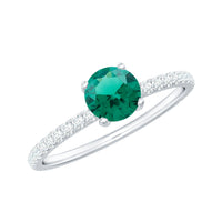 Certified lab-grown emerald solitaire engagement ring with diamond, featuring a sleek band and vibrant green gemstone.