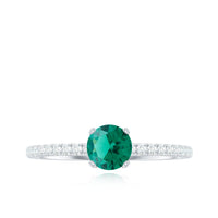 Lab-grown emerald solitaire engagement ring with diamond accent, featuring a silver band and a prominent green emerald gemstone.