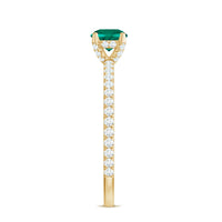 Lab grown emerald solitaire engagement ring with diamond accents, set in a delicate ring band, from Rosec Jewels.