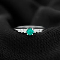Round Lab Grown Emerald Diamond Promise Ring by Rosec Jewels, featuring a sparkling emerald and diamond accents on a polished band.