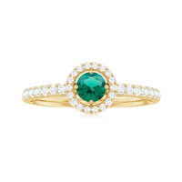Certified lab-grown emerald diamond halo engagement ring featuring a central emerald and sparkling diamonds in a rose gold setting.