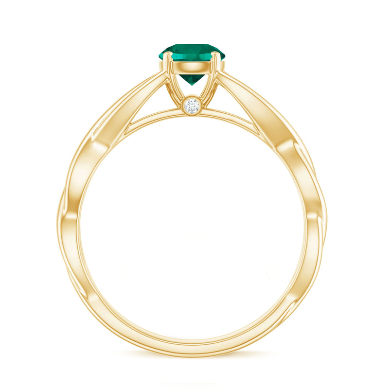 Lab-grown emerald crossover ring with diamond accents, crafted by Rosec Jewels, featuring a sleek gold band and intricate design.