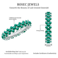 Certified lab-grown emerald eternity ring by Rosec Jewels, featuring a continuous row of sparkling green emeralds on a silver band.