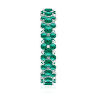 Certified lab-grown emerald eternity ring by Rosec Jewels featuring a continuous line of vibrant green emeralds set in a sleek band.