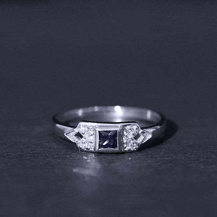 Rosec Jewels art deco style ring featuring a princess cut blue sapphire surrounded by diamonds, elegant jewelry for special occasions.