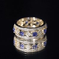 Lab created blue sapphire and diamond full eternity band ring by Rosec Jewels, featuring a row of sparkling gemstones on a gold band.