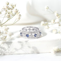 Lab-created blue sapphire and diamond full eternity band ring by Rosec Jewels, showcasing sparkling gemstones and elegant design.