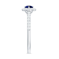 Lab grown blue sapphire diamond engagement ring with a halo setting, featuring a 0.6 carat center stone, from Rosec Jewels.