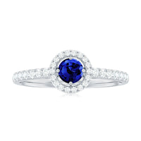Lab-grown blue sapphire and diamond halo engagement ring by Rosec Jewels featuring a 0.6 carat center stone and intricate band design.