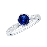 Lab-created blue sapphire engagement ring by Rosec Jewels featuring diamond side stones and a minimalist design.