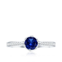 Blue sapphire engagement ring with diamond side stones from Rosec Jewels, featuring a minimalist design and lab-created gemstone.