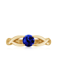 Lab grown blue sapphire promise ring with a surprise diamond, featuring a 0.6 carat center stone and elegant band design.
