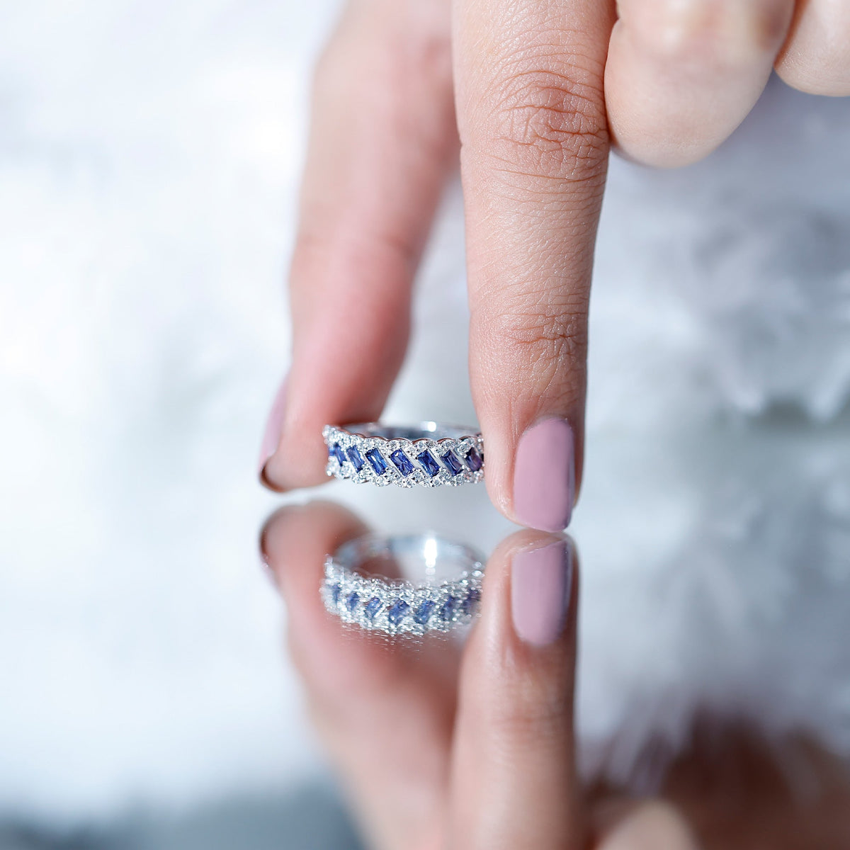 Rosec Jewels lab-grown blue sapphire and diamond half eternity band ring with baguette-cut sapphires and sparkling diamonds.