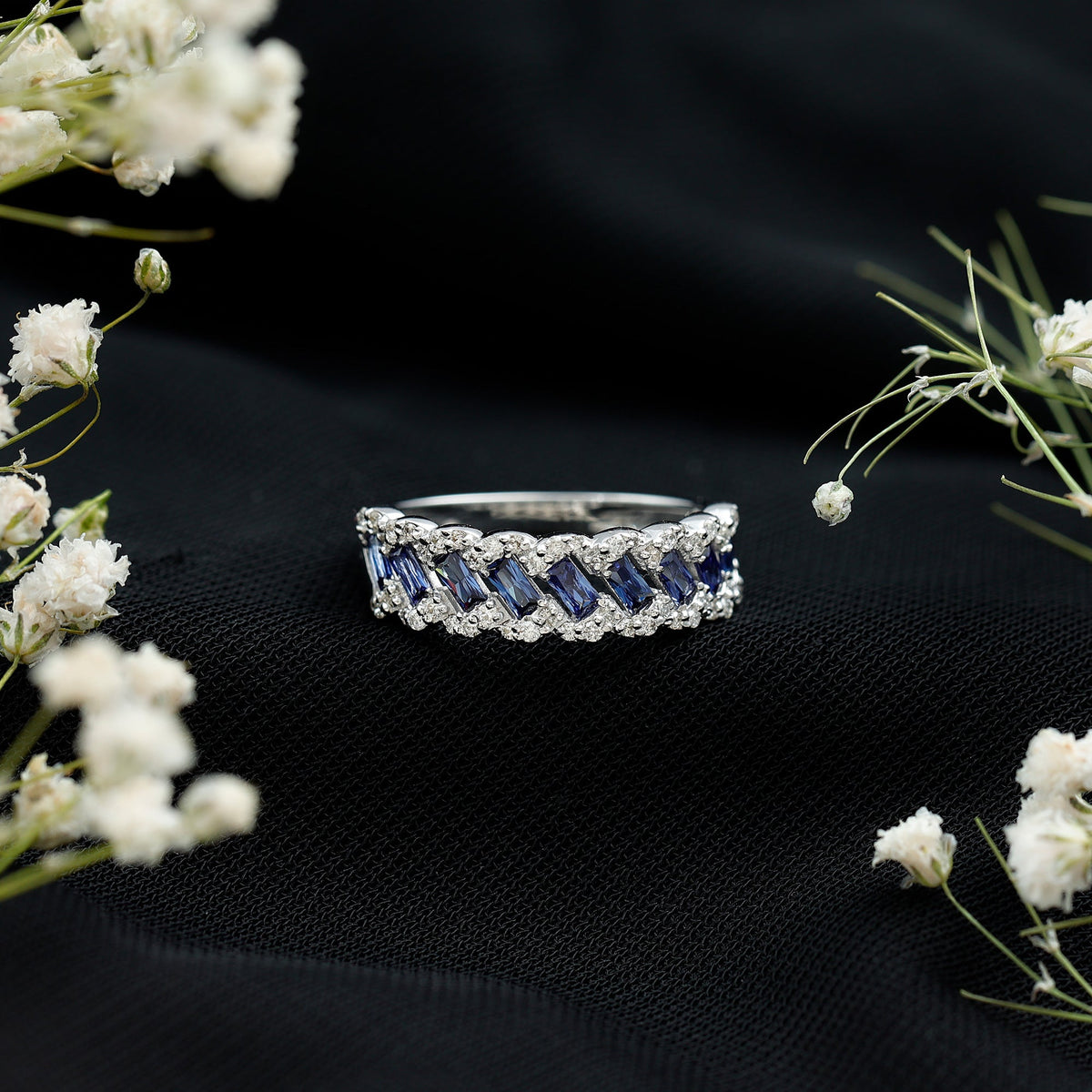 Rosec Jewels blue sapphire and diamond lab-grown baguette eternity ring with half eternity band, showcasing blue sapphires and sparkling diamonds.