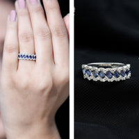 Rosec Jewels lab-grown blue sapphire and diamond eternity ring featuring a baguette design and half-band setting.
