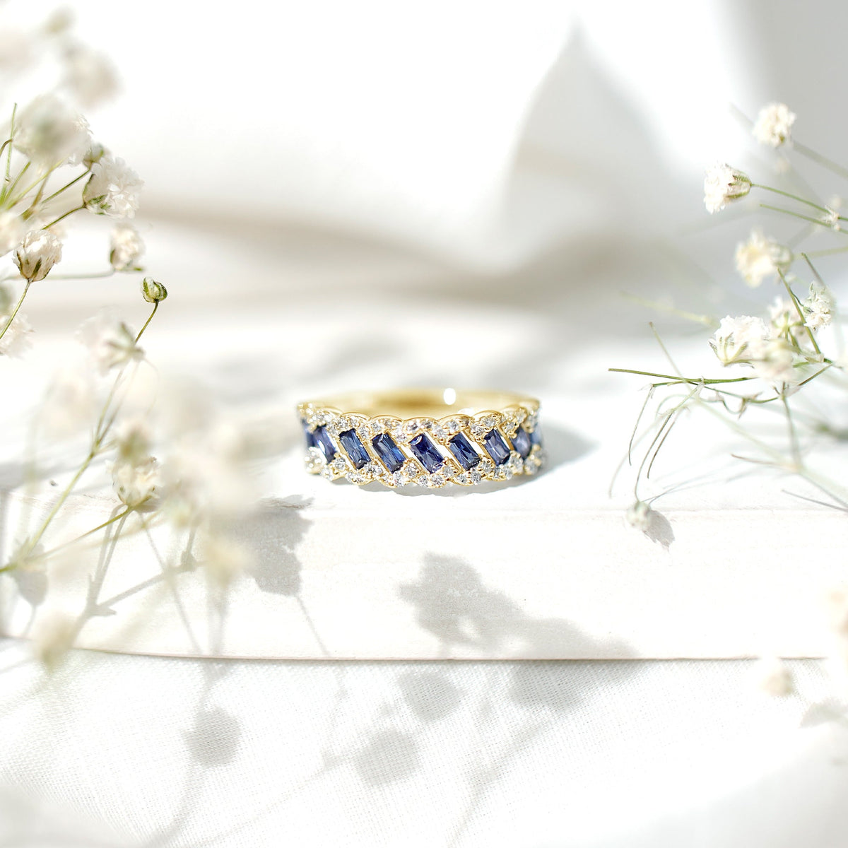 Rosec Jewels blue sapphire and diamond half eternity band ring with lab-grown baguette sapphires and sparkling accents.