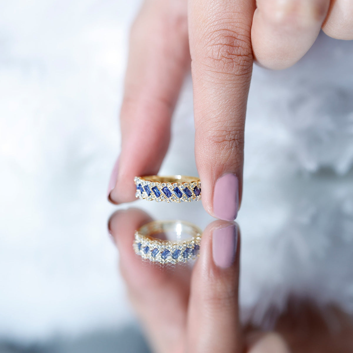 Rosec Jewels blue sapphire and diamond half eternity ring featuring lab-grown blue sapphires and a sleek band design.