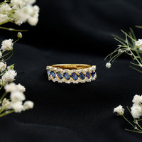 Rosec Jewels blue sapphire and diamond half eternity ring featuring lab-grown blue sapphires and a polished band.