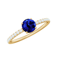 Lab-created blue sapphire promise ring with diamond side stones, featuring a 5mm blue sapphire centerpiece from Rosec Jewels.